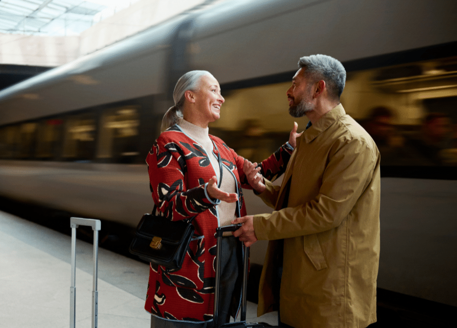 Old man and woman standing near train