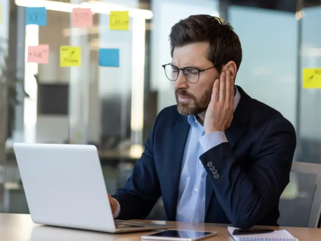 Man holding ear-The Top 5 Reasons why Microsuction is the Best Choice for Ear Wax Removal Man holding ear-The Top 5 Reasons why Microsuction is the Best Choice for Ear Wax Removal